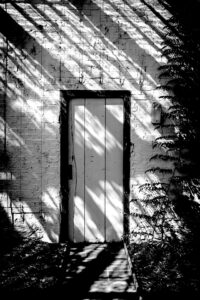 closed-door-sunlight-ben-wicks-ptmRZWNpgz4-unsplash(https-::unsplash.com:photos:a-door-in-a-brick-wall-ptmRZWNpgz4)