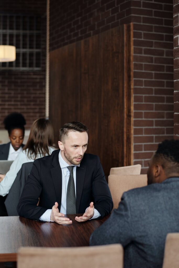 photo of a lawyer or middleman talking at table
