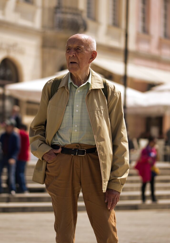 Photo of an older man in a plaza with a bewildered appearance like someone would lose God because they became distracted