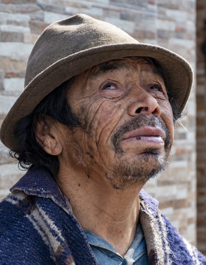 A humble indigenous man looking upward