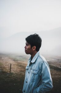 man-looking-kilarov-zaneit-iLc4v9JcZi8-unsplash(https-::unsplash.com:photos:man-wearing-blue-denim-jacket-under-foggy-weather-iLc4v9JcZi8)