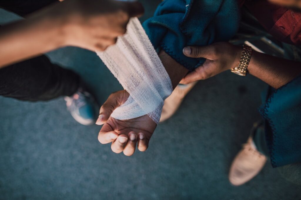 The hand of a person being bandaged, symbolizing how God cares for you