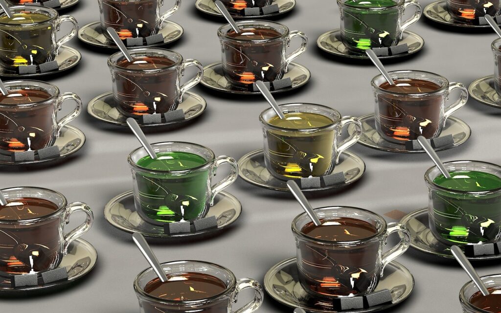 A nearly identical series of clear glass coffee cups with different colored liquids and a metal spoon in each symbolizing how IP theft makes fakes of original works