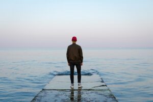 man-on-dock-looking-to-horizon-nicholas-barbaros-YoF79VE9Sec-unsplash(https-::unsplash.com:photos:man-standing-on-concrete-dock-facing-sea-YoF79VE9Sec)