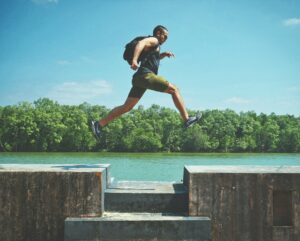 running-leaping-jordan-opel-ybLtRkjHprE-unsplash(https-::unsplash.com:photos:man-leaping-on-concrete-surface-near-body-of-water-and-forest-at-the-distance-during-day-ybLtRkjHprE)