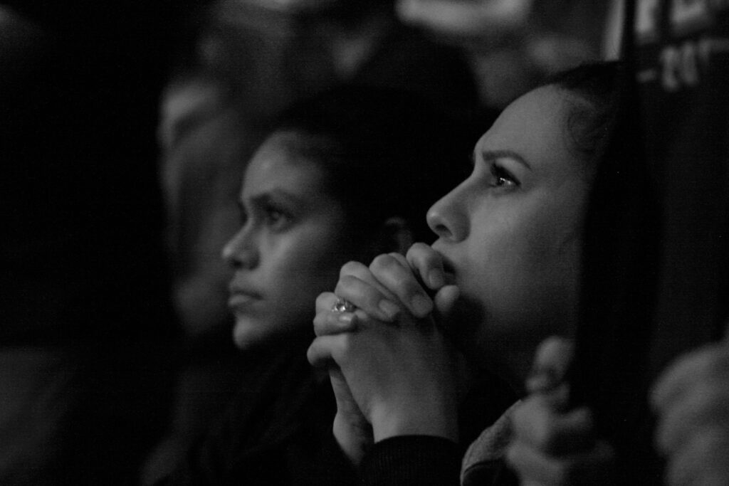 A black and white photo of two women looking upward at another object symbolic of how we are seeing ourselves as God sees us