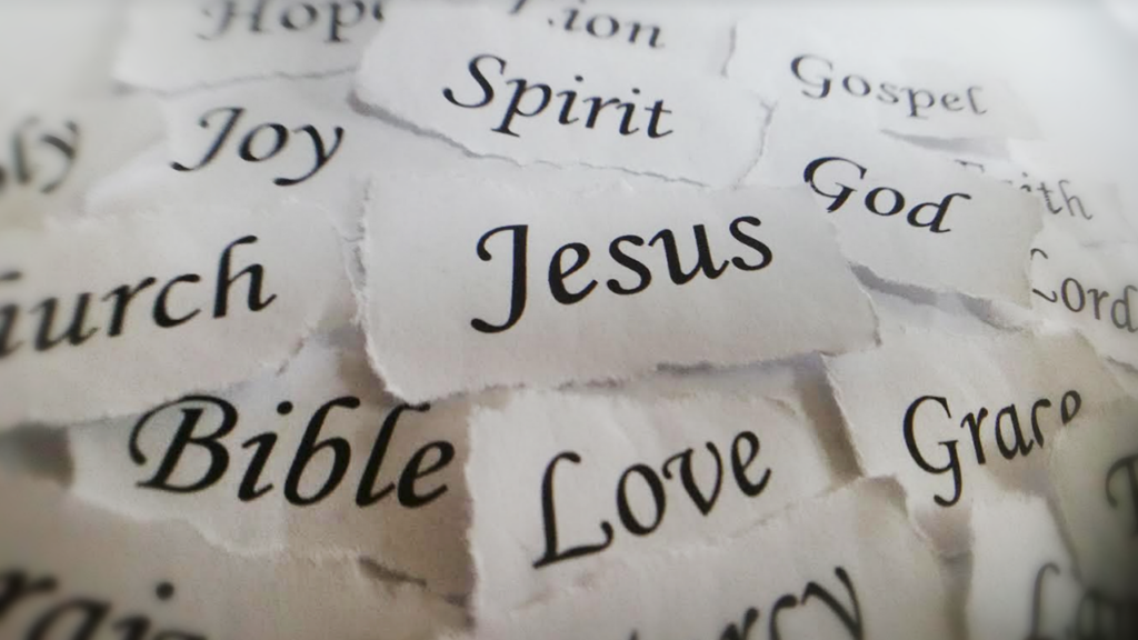 A collection of Biblical words ripped out and placed in a pile symbolic of removing a word for the Bible and making it fit somewhere else