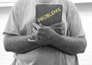 person holding book of probkems