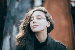 young-woman-eyes-closed-outdoors-eli-defaria-vCzh1jOyre8-unsplash(https-::unsplash.com:photos:closeup-photo-of-woman-wearing-black-top-vCzh1jOyre8)