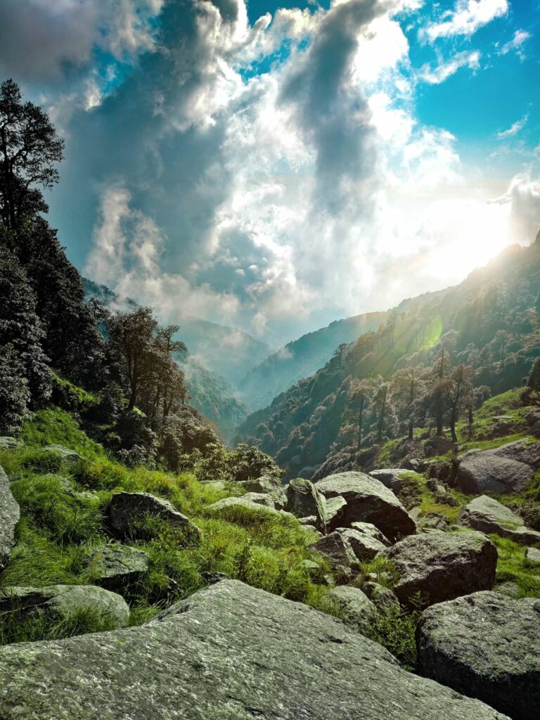 A burst of sun over a clouded mountainous valley symbolic of the reward that is to come for those who trust in God